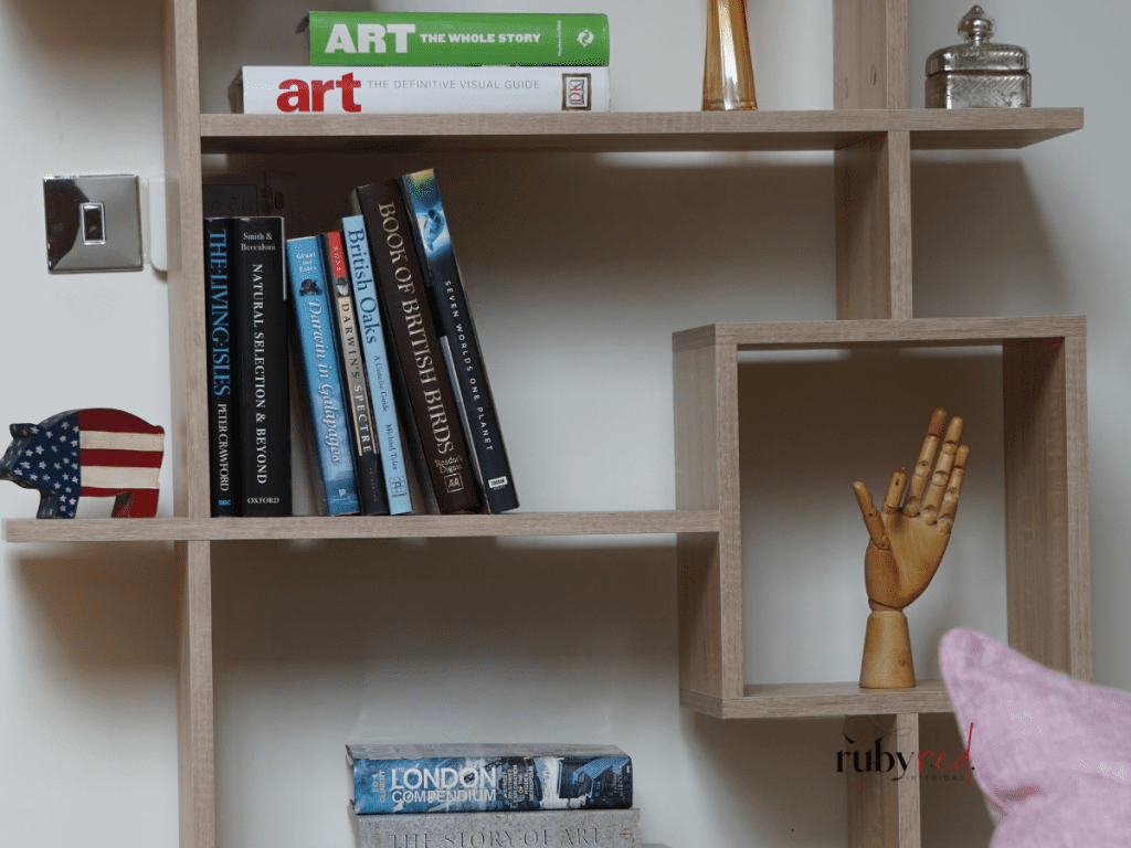 Wooden wall shelves with books and decorative pieces — rustic cottage home decor.