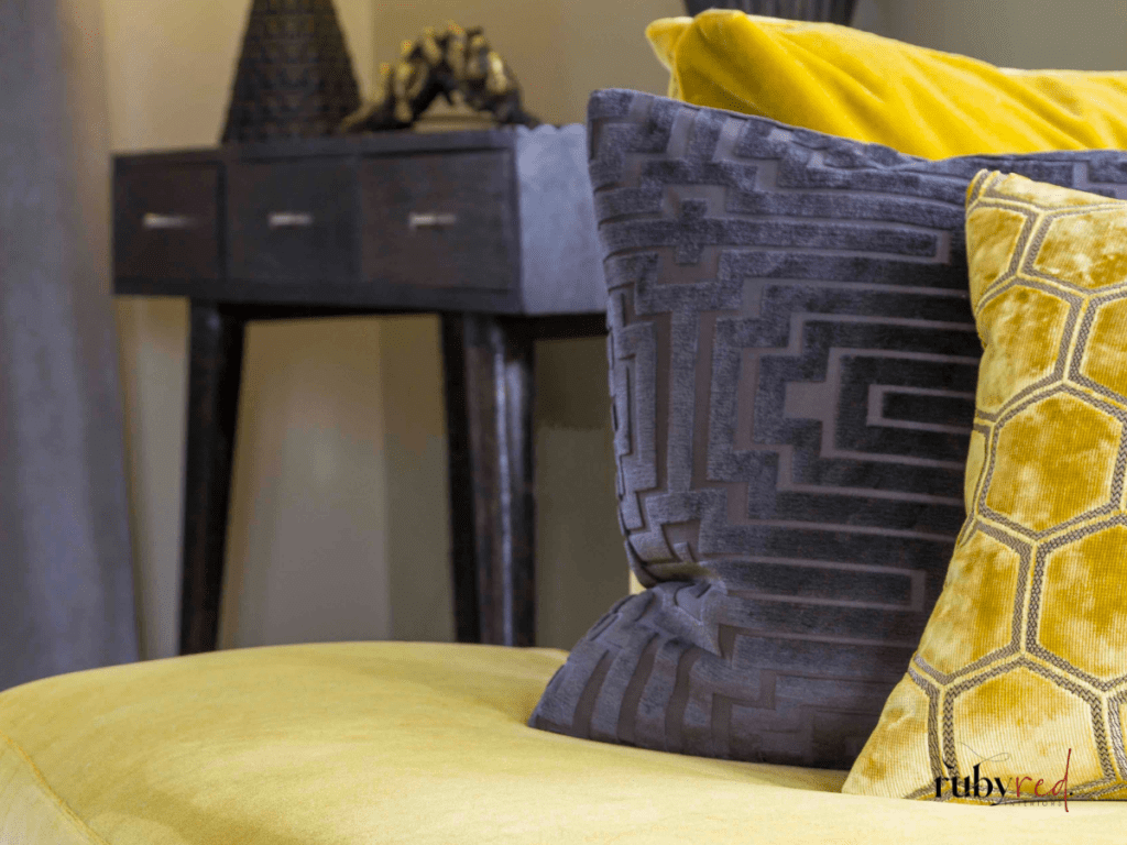 Modern farmhouse cushions in warm yellow and charcoal grey velvet — cosy living room styling ideas.